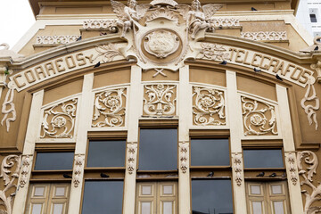 The facade of the 1917 Postal Building with the inscription Mail and Telegrams or Correos y...