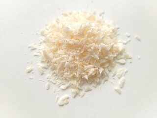 Coconut flakes on bright background.