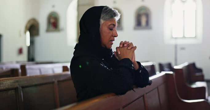 Sad, woman and praying in church with faith at funeral, service and memorial ceremony in religion for death. Mourning, widow and thinking of memory or respect prayer with worship in Christian chapel