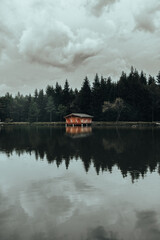 Lake with a hut in a moody rainy weather