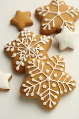 Tasty Christmas cookies with icing on white background, closeup
