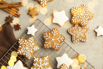 Tasty Christmas cookies with icing and spices on light table, flat lay