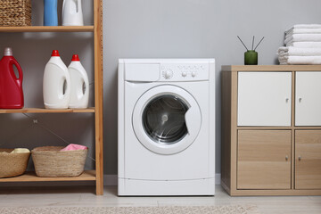 Laundry room interior with washing machine and furniture - obrazy, fototapety, plakaty