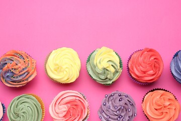 Delicious cupcake with bright cream on pink background, flat lay