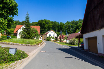 Fototapeta na wymiar Houses, chapel and trees in village Leienfels, district of Pottenstein (Franconian Switzerland), Bavaria, Germany