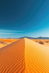 Fototapeta na wymiar Sweeping Orange Sand Dunes Under Blue Sky