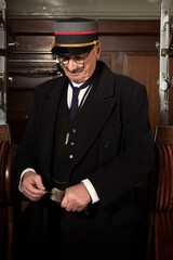 Vintage train conductor in Victorian train