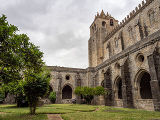 Fototapeta na wymiar View of the magnificent Gothic cloister of the largest medieval cathedral in Portugal, Évora Cathedral. In the background the bells placed in the south tower.