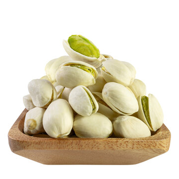 Pile of peeled and unpeeled Pistachio nuts in a wooden bowl isolated on white background