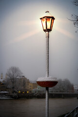 The street lamps are lit at night in winter.Lighting in the dark in a snowstorm.