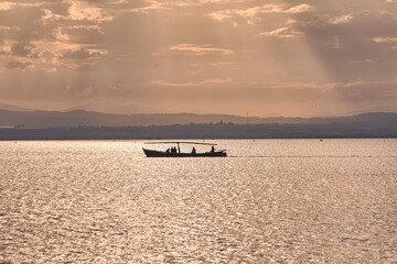 Silhouette of boat full of people in the Albufera of Valencia
