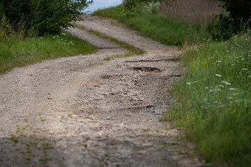 Gravel road after heavy rainfall - some larger leaching; the road has to be repaired. 