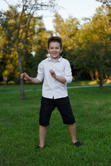 Full length image of a funny boy, playing in the park.