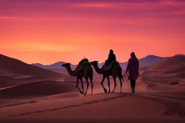 Poster Spectacular desert sunset landscape with camels, sand dunes, and pink skies over the horizon at dusk © vetrana