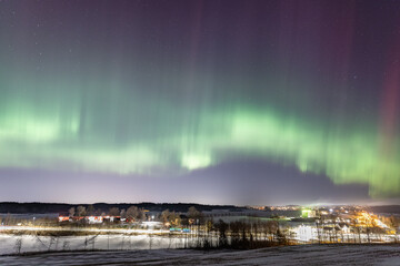 Picture of green and red aurora borealis during the winter in Norway