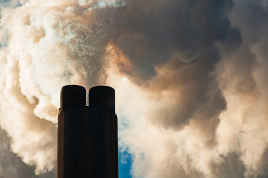 Closeup of the top of a smokestack releasing steam at a power plant in Rome, Georgia