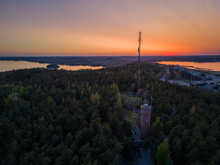 Aerial view of a sunset over a forest and lakes in Finland