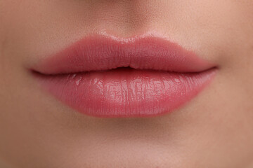 Young woman with beautiful full lips as background, closeup