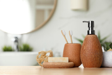 Bath accessories. Different personal care products and eucalyptus leaves on wooden table in bathroom, space for text