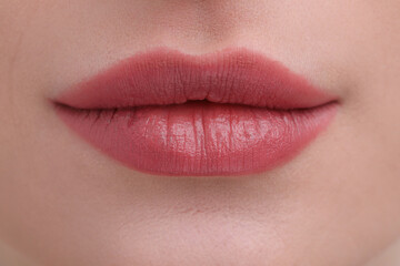 Young woman with beautiful full lips as background, closeup
