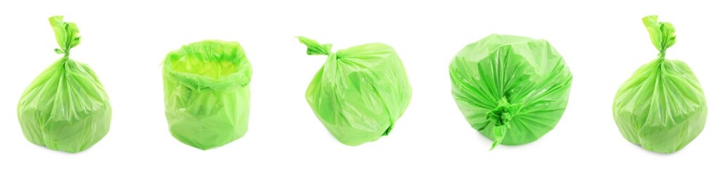 Green plastic garbage bags isolated on white, set