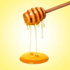 Natural honey dripping from dipper on yellow background