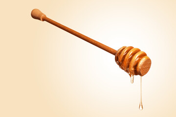 Natural honey dripping from dipper on beige background