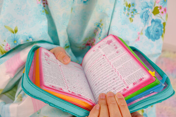 Muslim woman recite the koran on prayer mat and use prayer hijab.