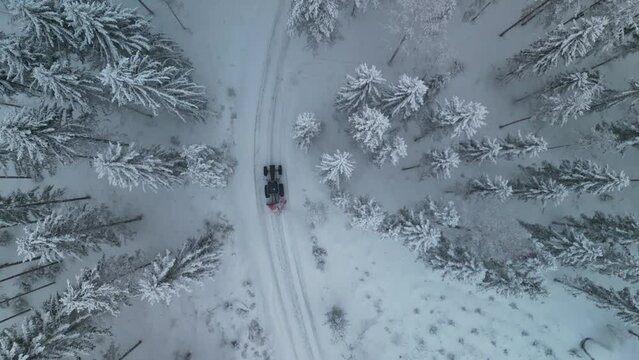 Aerial view of a tractor clearing snow with a snowblower in Finland