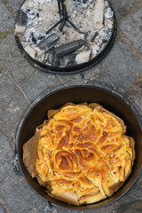 chelsea pan in the dutch oven with hot coals atop, , campfore cooking, bakery recipes.