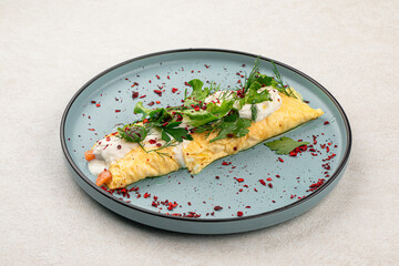 Portion of gourmet rolled omelette with salmon