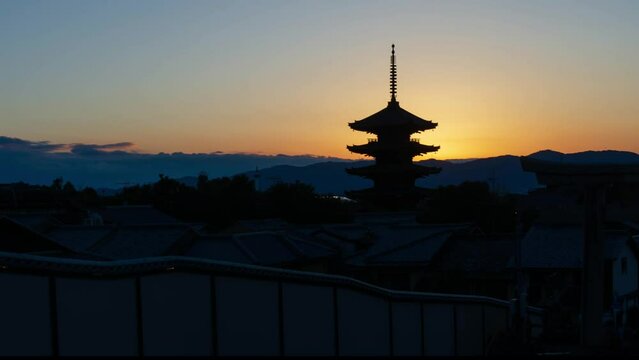 timelapse kyoto city aerial skyline view to ancient Yasaka pagoda building and Kyoto Tower at the back in higashiyama, Kyoto old town with sunset sky