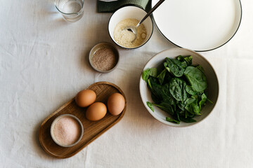 Ingredients for healthy and delicious food. Spinach leaves, eggs, salt, cottage cheese, psyllium