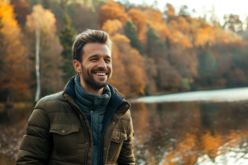 Man in  who exudes happiness and a sense of feeling truly alive in a beautiful natural park near a lake