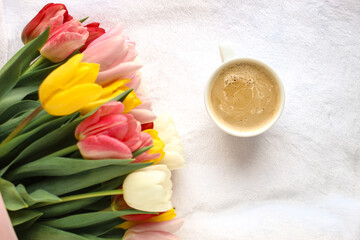 A bouquet of flowers and a cup of coffee 