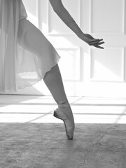 Beautiful ballerina dancing, close up on of hand and leg Femininity , Grace and Tenderness concept. Black and White image
