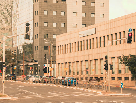 Urban intersection on HaMasger Street, Tel Aviv, with traffic lights, cars, and unique Hamsin weather ambiance