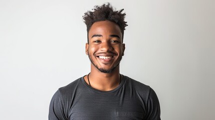 Obraz premium Young black boy, smiling portrait on white background, wears black t-shirt, short afro hair.