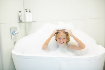 Child playing with foam in bath