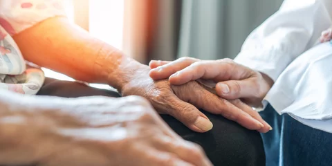 Foto op Canvas Parkinson disease patient, Alzheimer elderly senior, Arthritis person's hand in support of geriatric doctor or nursing caregiver, for disability awareness day, ageing society care service © Chinnapong