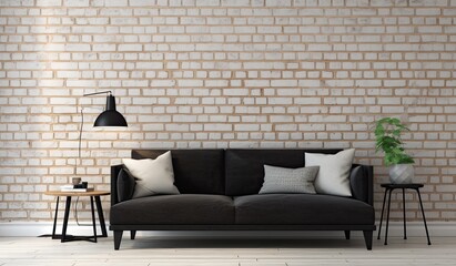 A black couch is in front of a white brick wall