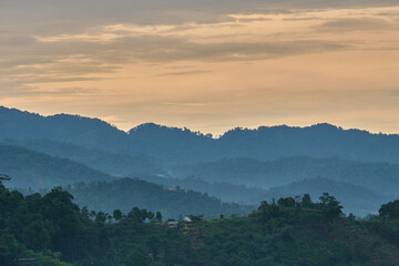 View of the hills in the afternoon after the rain is filled with mist