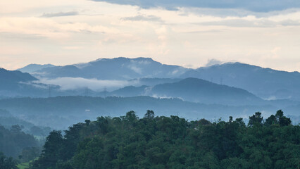 View of the hills in the afternoon after the rain is filled with mist