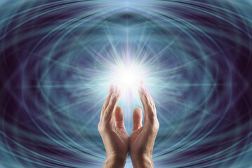 Reiki master working with Starlight Healing Energy - male cupped hands reaching up into bright...