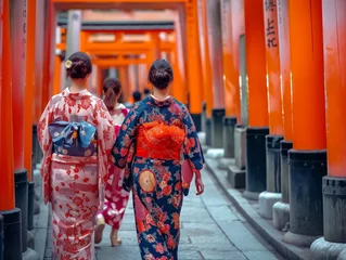 Gordijnen Women in traditional kimonos walk through the iconic torii gates, embodying Japan's rich cultural heritage. © cherezoff