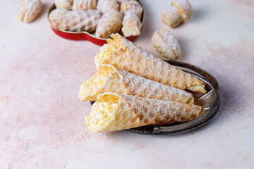 Homemade nut shaped russian soviet cookies and wafer rolls with pastry cream.