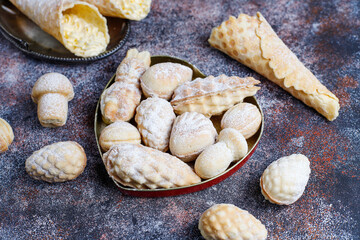 Homemade nut shaped russian soviet cookies and wafer rolls with pastry cream.