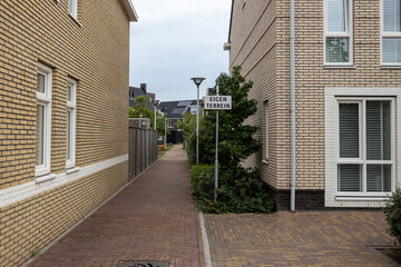 Deserted street in a modern Dutch residential area with a sign 