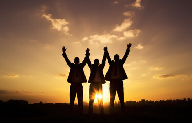 Three men are standing together in the sunset, holding hands and smiling