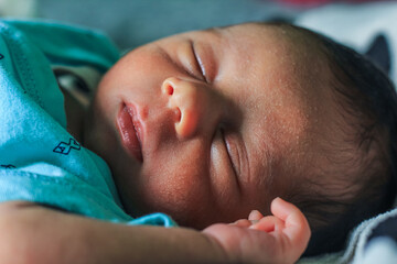Cute newborn baby sleeps with cute expression. Asian newborn baby sleeping. life concept.